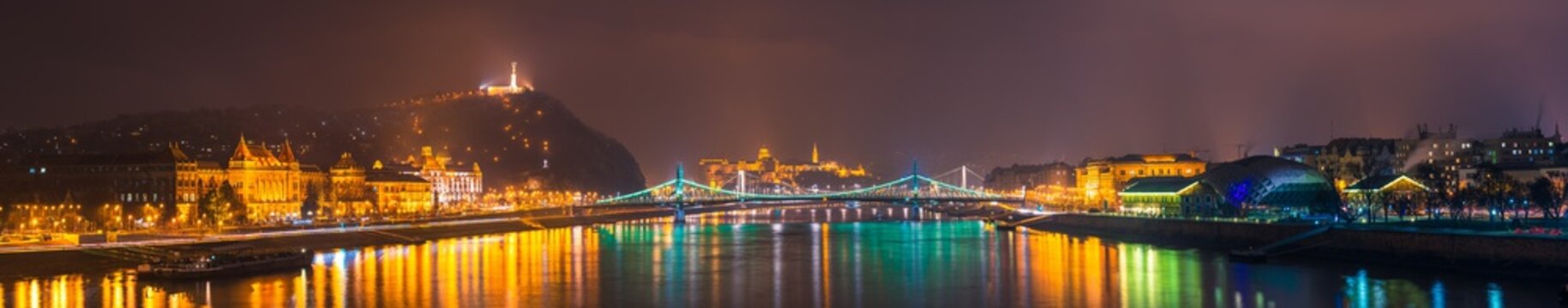 Night time skyline panorama of Budapest overlooking Liberty bridge and statue. Hungary 