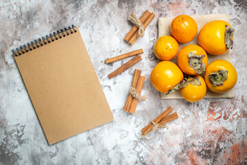 top view fresh persimmons with cinnamon on a light background photo fruit tree healthy life ripe color