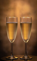 Champagne glasses over holiday bokeh blinking background, rotating on turntable, glasses with sparkling wine, celebration, party. High quality 4k footage
