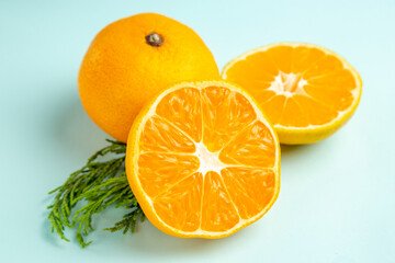 front view fresh tangerine slices on light-blue background photo fruits color citrus orange