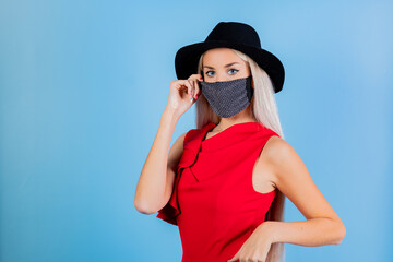 Fashion woman in trendy dress and cap. Sexy female posing in light blue background. Fashionable...