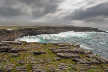 Powerful waves hist rocks at the bottom of cliff. Inishmore, Aran islands, county Galway, Ireland....