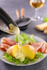 raclette cheese with potato,  ham and lettuce
