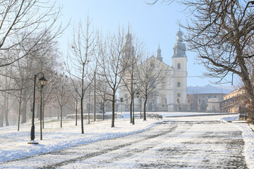 KALWARIA ZEBRZYDOWSKA, POLAND - DECEMBER 11, 2020: Way to Basilica in Kalwaria Zebrzydowska, covered with snow.