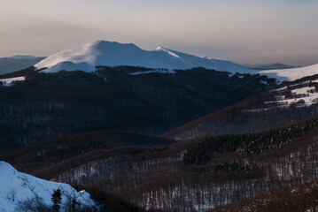 Winter in the Carpathians. Mountain landscape of Eastern Europe. Bieszczady mountains covered in snow during a sunset.