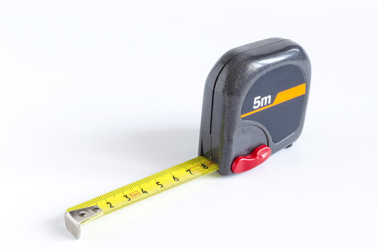 Plastic measuring tape with extended ruler on a white background close-up	