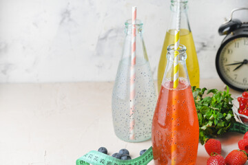 Three bottles of a drink with basil seeds. Light photography with copy space.