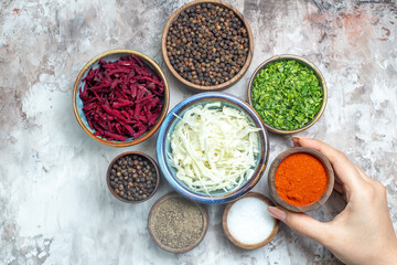 top view different seasonings with sliced cabbage greens and beet on white desk photo pepper food