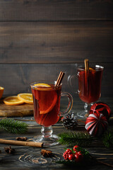 Warming Christmas drink with orange and cinnamon. Atmospheric shot of mulled wine.