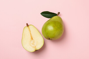 Fresh green pears on pink background, top view