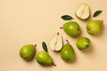 Fresh green pears on beige background, top view