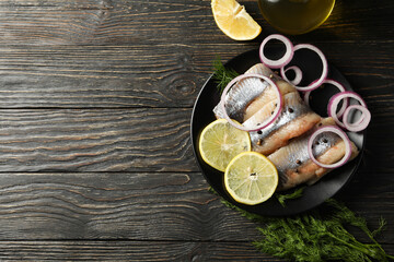 Concept of tasty lunch with herring fish on wooden background