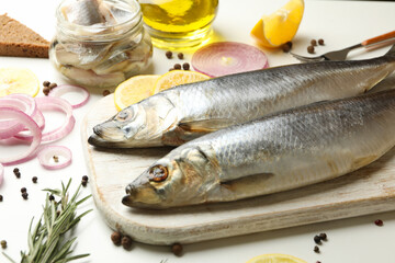 Concept of tasty lunch with fresh herring fish on white background