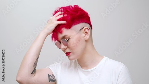 Young Beautiful Girl With A Short Bob Haircut Red Colored Dyed Hair And Sunglasses The Model Poses In The Studio On A White Background Wall Mural Spaskov