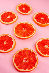 Fototapeta na wymiar front view tasty grapefruits sliced juicy fruits on pink background healthy life juice fresh color diet