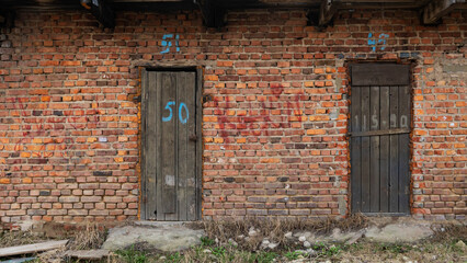 An Old Wooden Doors In An Abandoned Brick Warehouse. Background for design. Space for text.