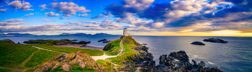 Fototapeta na wymiar Sunset panorama of Lighthouse on Llanddwyn Island at the coast of Anglesey in North Wales,UK