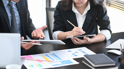Cropped shot of business people using tablet consultant discussing in data documents at modern office.