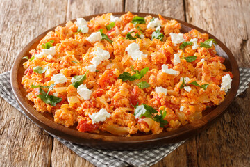 Greek Fresh Tomato and Feta Egg Scramble Kagiana or Strapatsada closeup in the plate on the table. horizontal