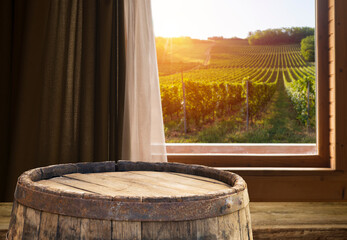 Glass of red wine standing on windowsill with autumn leaves and a fogged window in the background