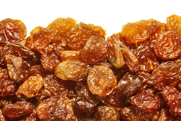 Close up of golden sultana raisins on white background, selective focus.