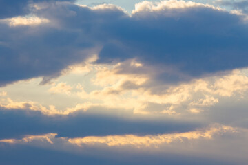 Fototapeta na wymiar cloudy sky in yellow light. natural background at sunrise. inspiring scene