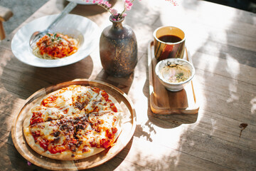 Homemade pizza on wooden table. Table with food in spring.