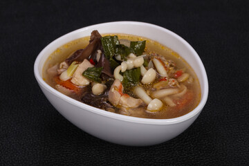 Thai style soup with meat and mushrooms
