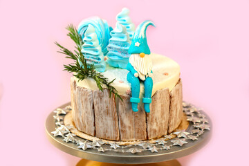 New Year's festive Christmas cake on a stand on a pink background. Christmas sweets decorated with New Year's decor and berries.