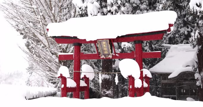 Snowfall and snow covered shrine in Japan / 4K
