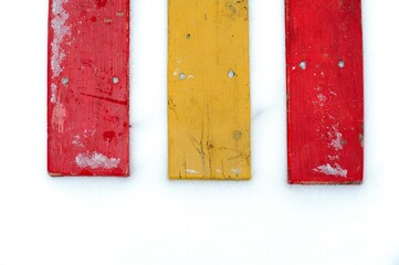 Red yellow and another red board lie in the snow