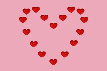 A big heart made up of small hearts on a pink background. Valentine's Day