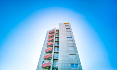 Residential building under blue sky with white circle
