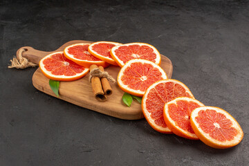 front view fresh grapefruit slices on a dark background color fresh healthy life diet juice fruit