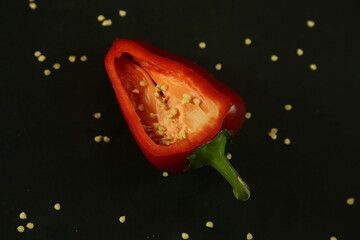 Red peppers on black background