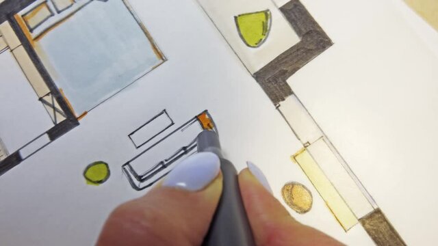 Woman drawing architecture apartment interior design sketch with orange marker in hand and POV attached 4K Camera.
