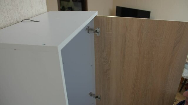 Protection furniture tip over man opens a wardrobe