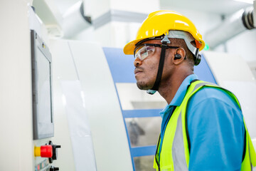 Black African American worker man control with industry machine at industrial factory. technology invention manufacturing. career and professional skill. diversity people working together. copy space