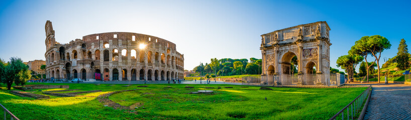 Panorama of Colosseum and Constantine arch at sunrise in Rome, Italy  - obrazy, fototapety, plakaty