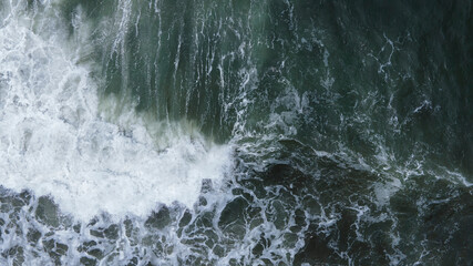 Beautiful scenic aerial landscape of splashing ocean waves with foam bubbles. High quality photo