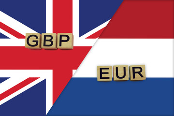 Obraz premium United Kingdom and Netherlands currencies codes on national flags background