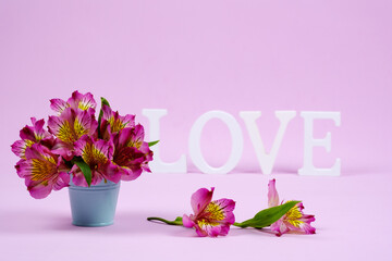 St.Valentine's card. Purple alstroemerias with the word love