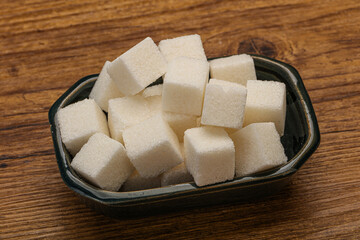 Refined white sugar cubs in the bowl