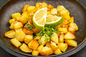 front view tasty fried potatoes inside pan with lemon slices on dark background color calorie cuisine meal food