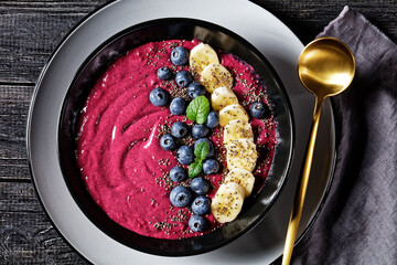 Blueberry and banana smoothie on a black plate