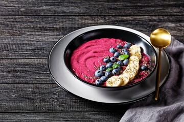 Blueberry and banana smoothie on a black plate