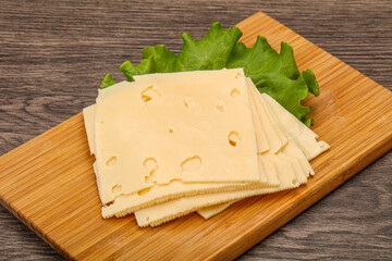 Sliced yellow cheese over board