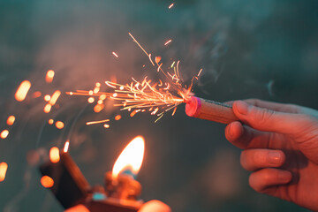 Young Man Lighting Up Firecracker in his Hand Using Gasoline Lighter. Guy Getting Ready for New...