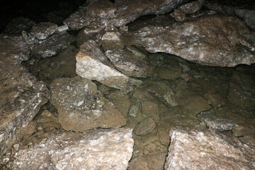 mountain textures of stones with interlayers of gypsum, colored quartz, clay, sand and other layers of various ores, with different textures, color and density, in gypsum ore quarry.