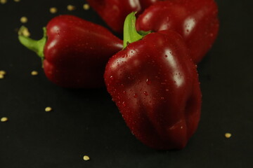 Red peppers on black background